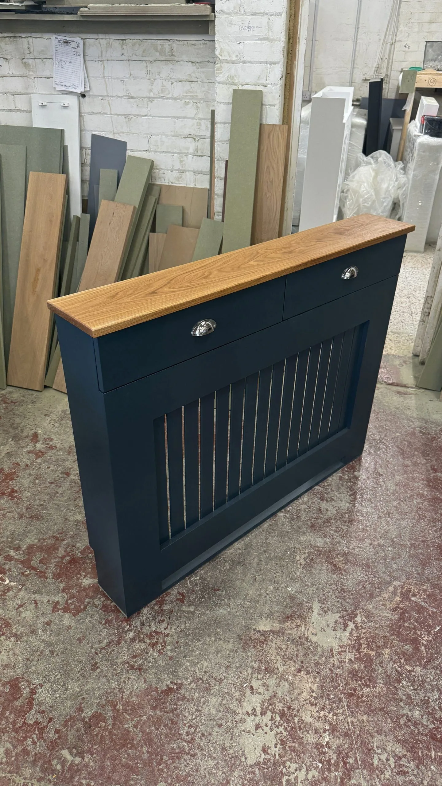 Custom white bespoke radiator cover with two functional drawers in a modern home