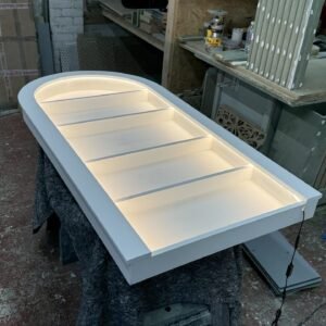 Bespoke curved floating salon wall unit with warm white LED lighting and white backing