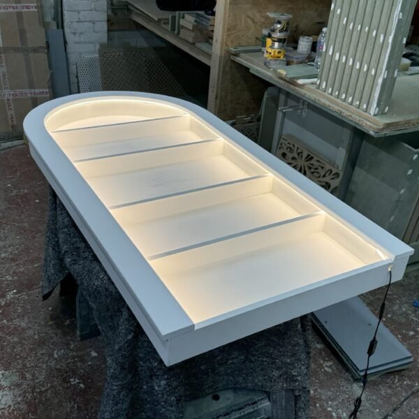 Bespoke curved floating salon wall unit with warm white LED lighting and white backing