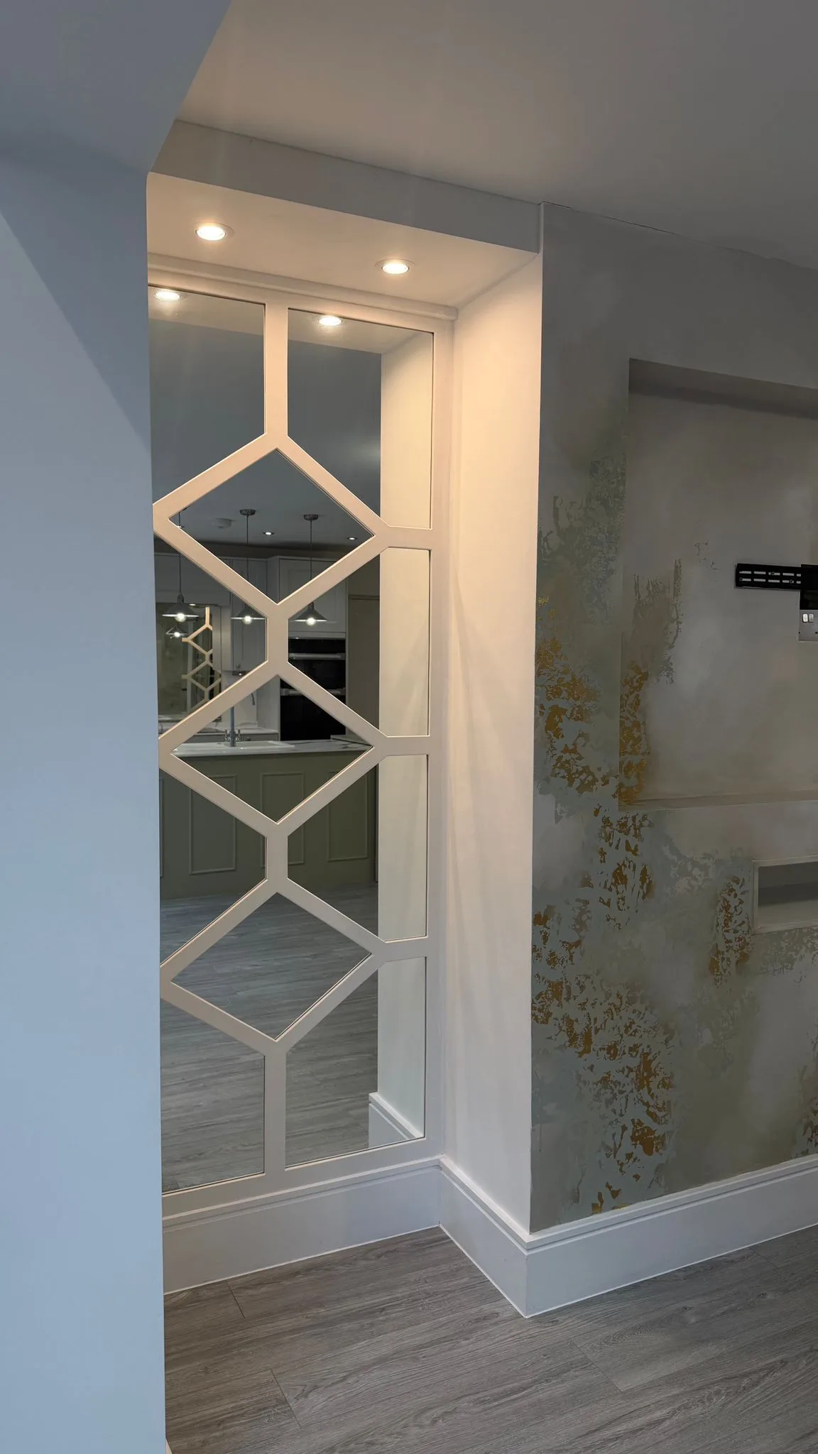 Bespoke grey diamond fretwork wall panelling with luxury mirrored backing for a feature wall