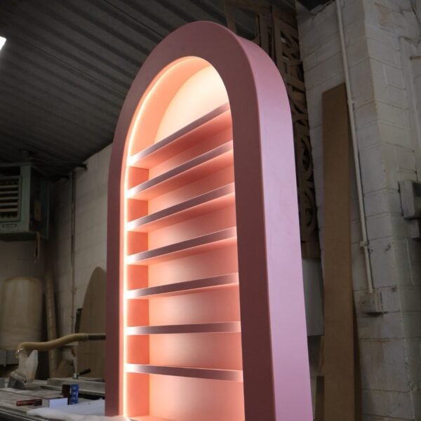 Bespoke curved pink nail polish display rack with warm LED backlighting