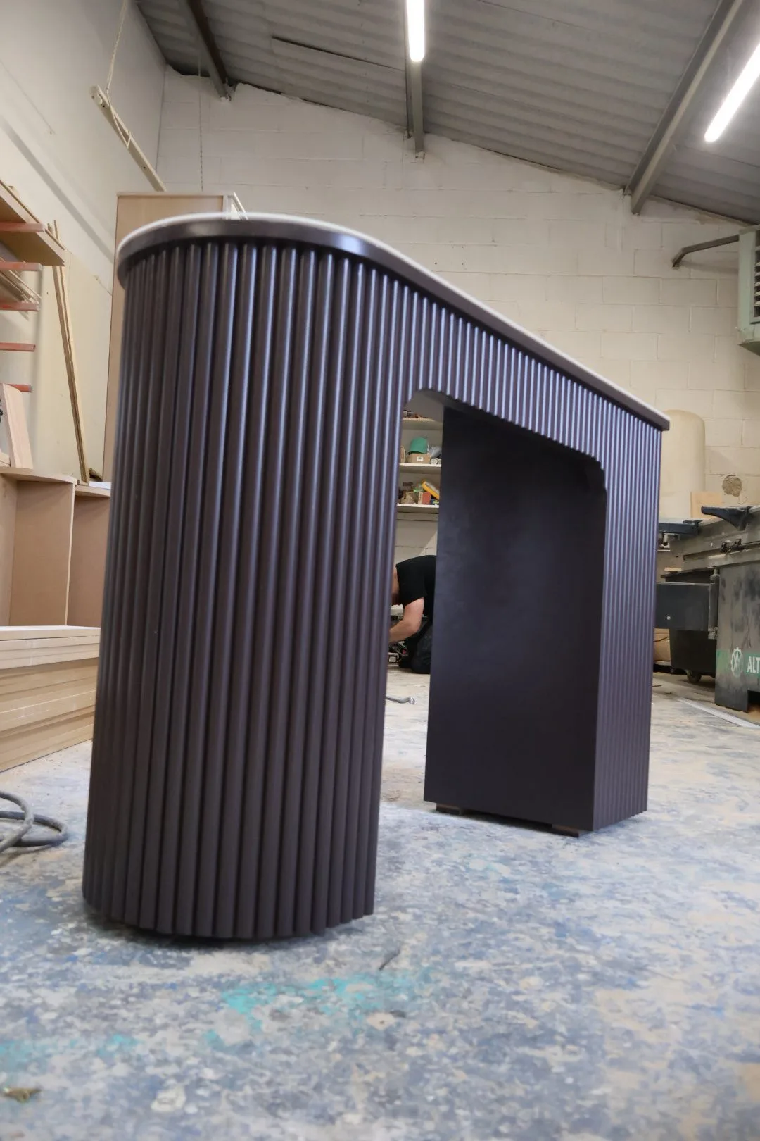 Bespoke reeded wood nail desk with fluted pine detail and protective glass top