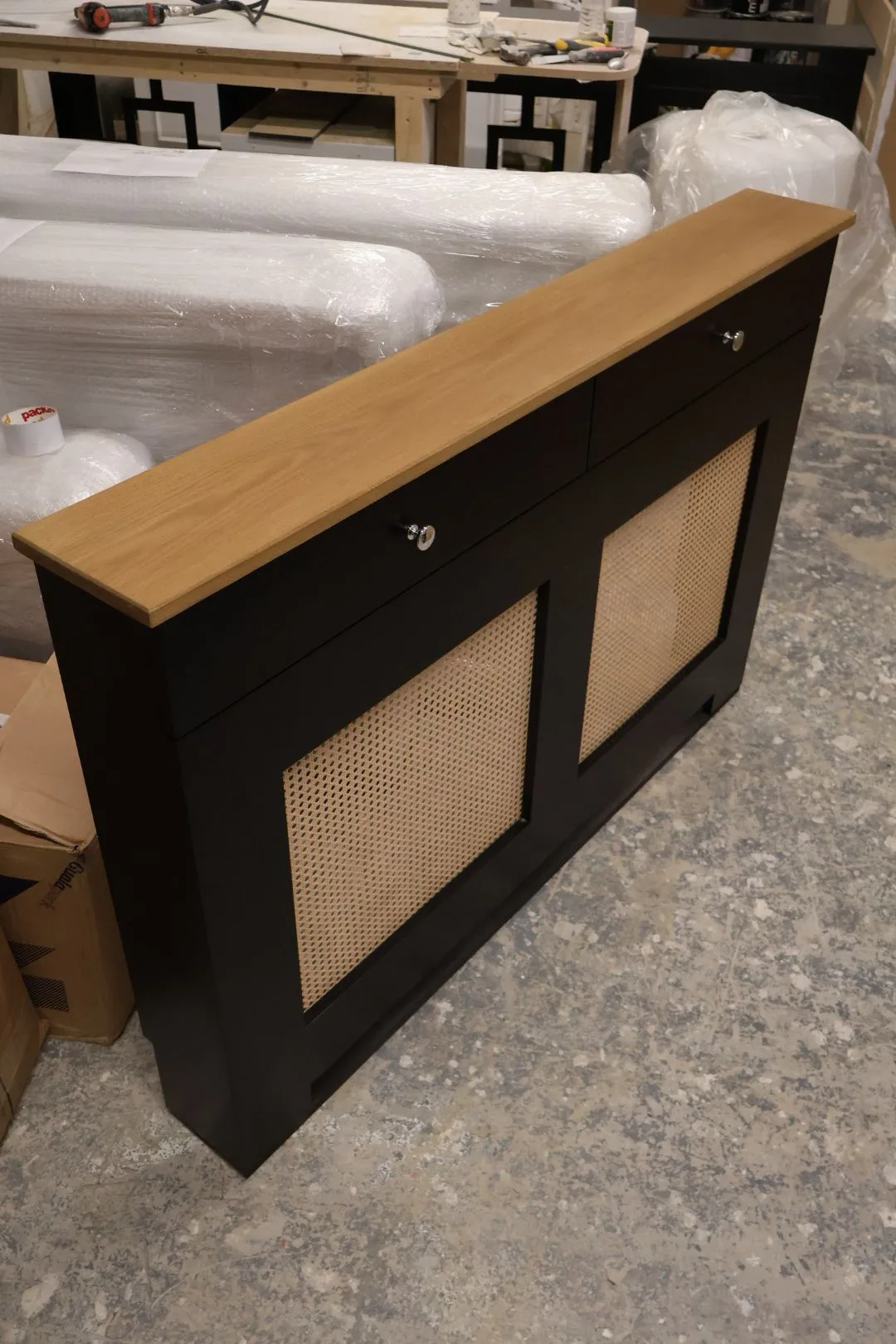 Bespoke white radiator cover with drawers and natural solid oak top in a modern hallway